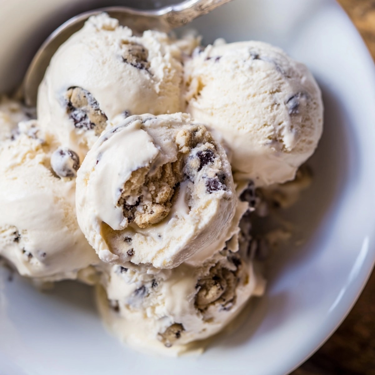 Scoops of creamy Cottage Cheese Ice Cream with Cookie Dough nestled in a bowl.