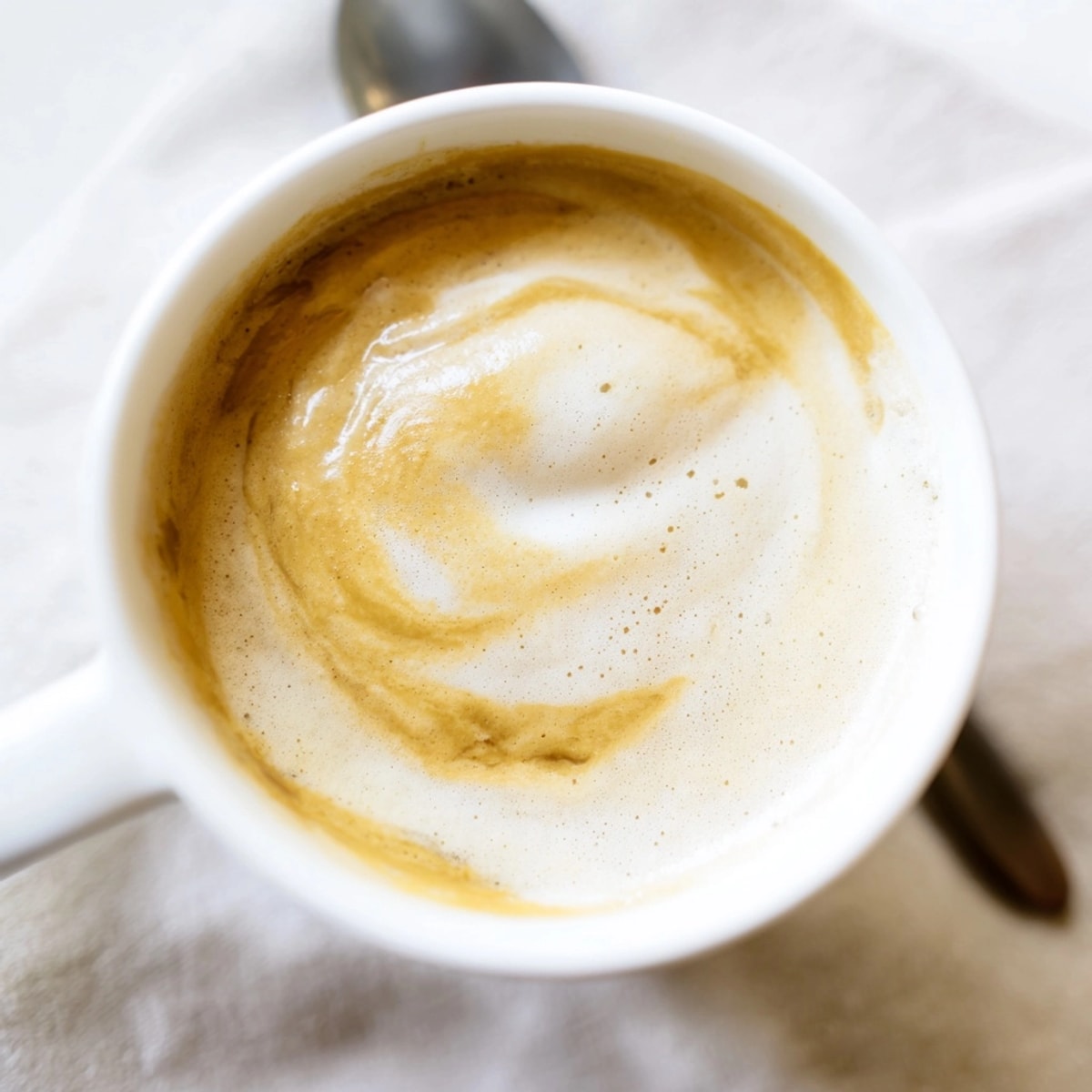 Creamy Onion Latte in a clear mug, showcasing the frothy top and savory flavor.