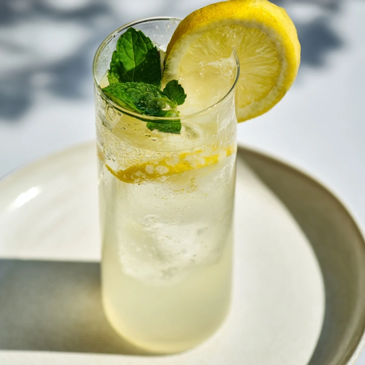 Bright yellow lemonade in a pitcher, perfect for this American recipe on a hot day.