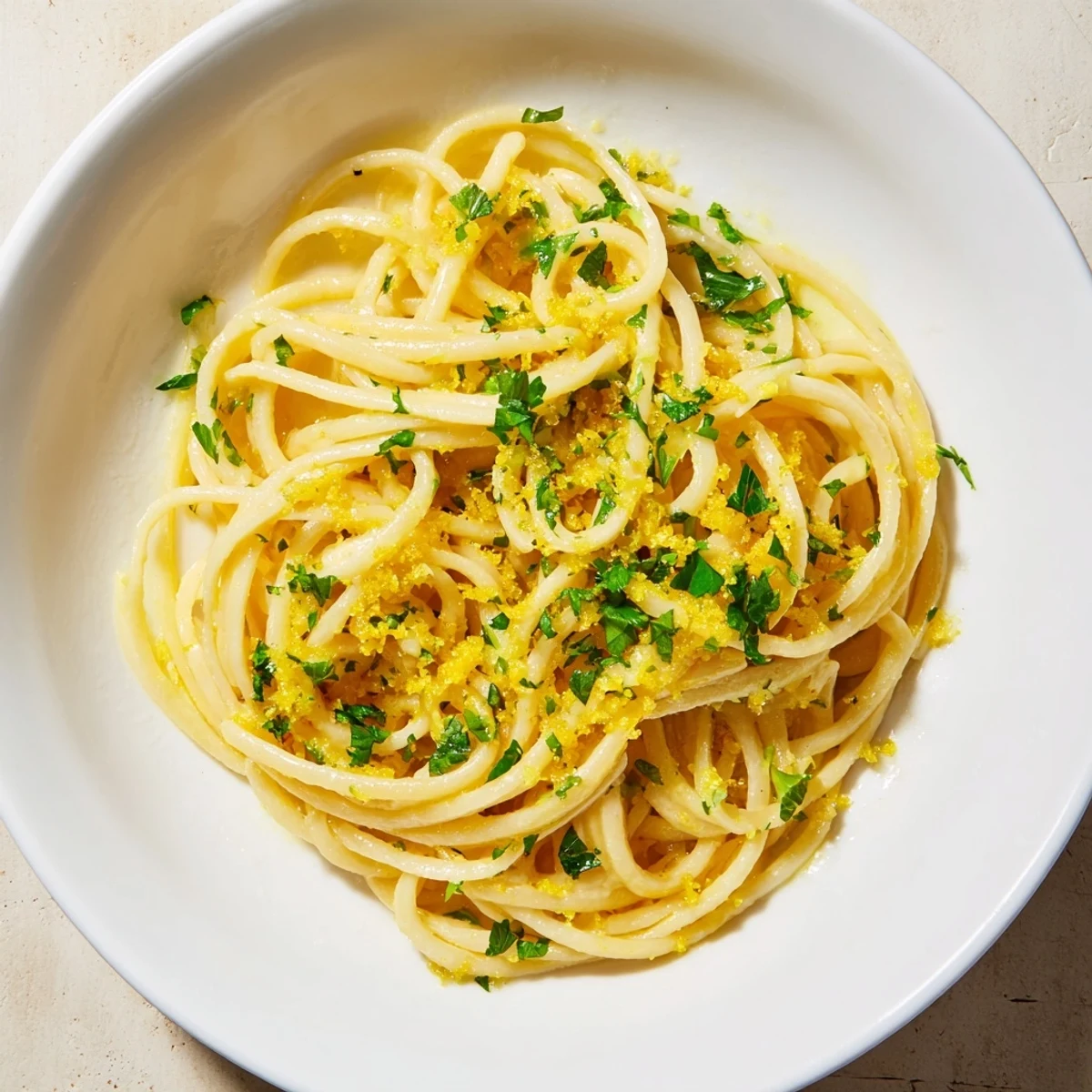 Close-up of steaming lemon garlic pasta, ready to serve, with a glossy sauce and enticing aroma.