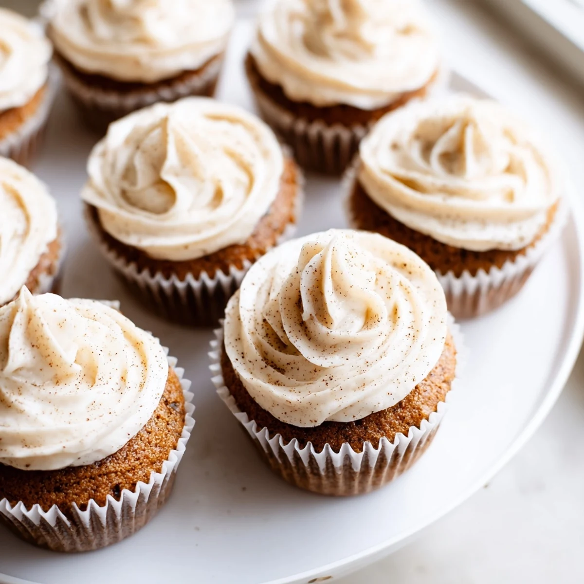 Warm, spiced Gingerbread Cupcakes with cream cheese frosting, a delicious dessert with festive appeal.