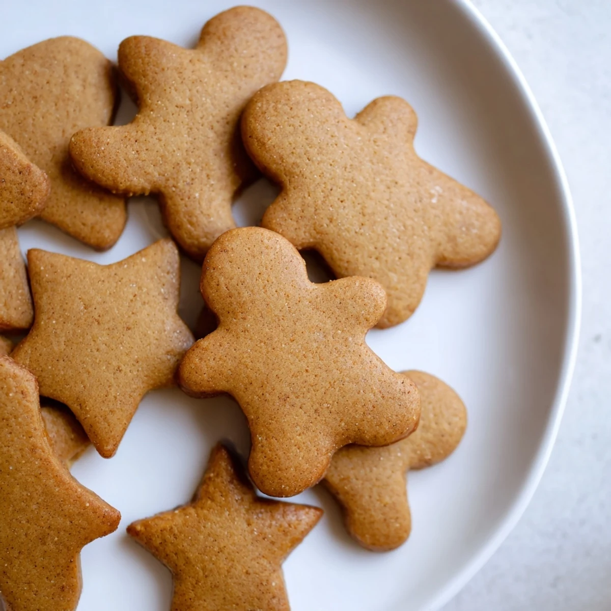 Festive gingerbread cutout dough cookies, golden brown and perfectly shaped for a holiday treat.