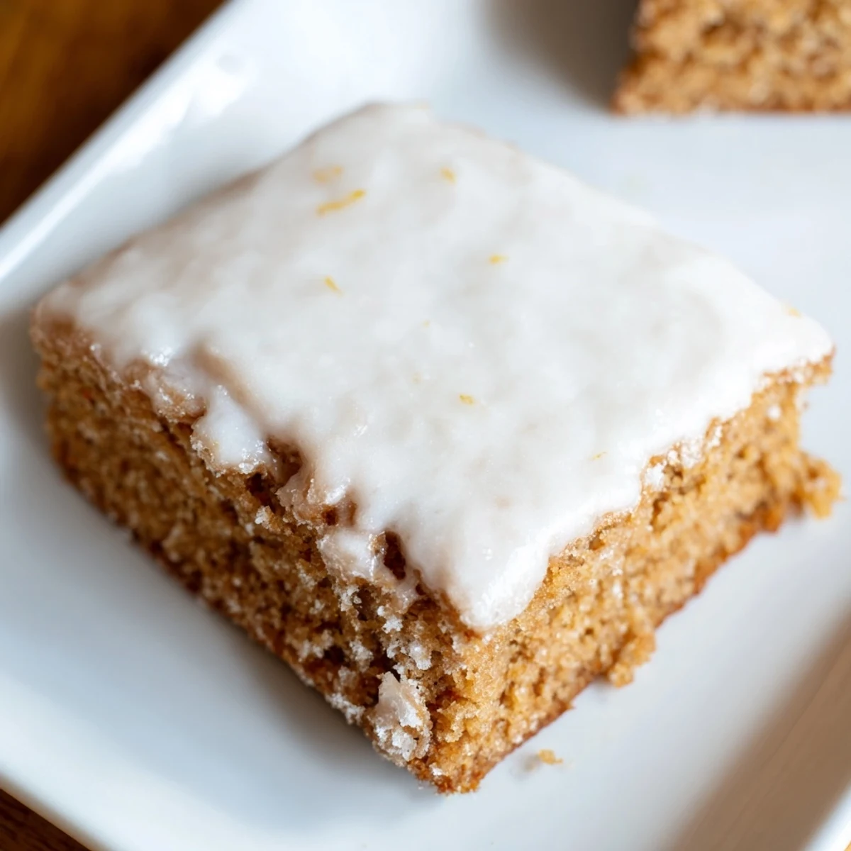 Freshly baked Iced Gingerbread, glistening with sweet icing, ready to slice and savor.