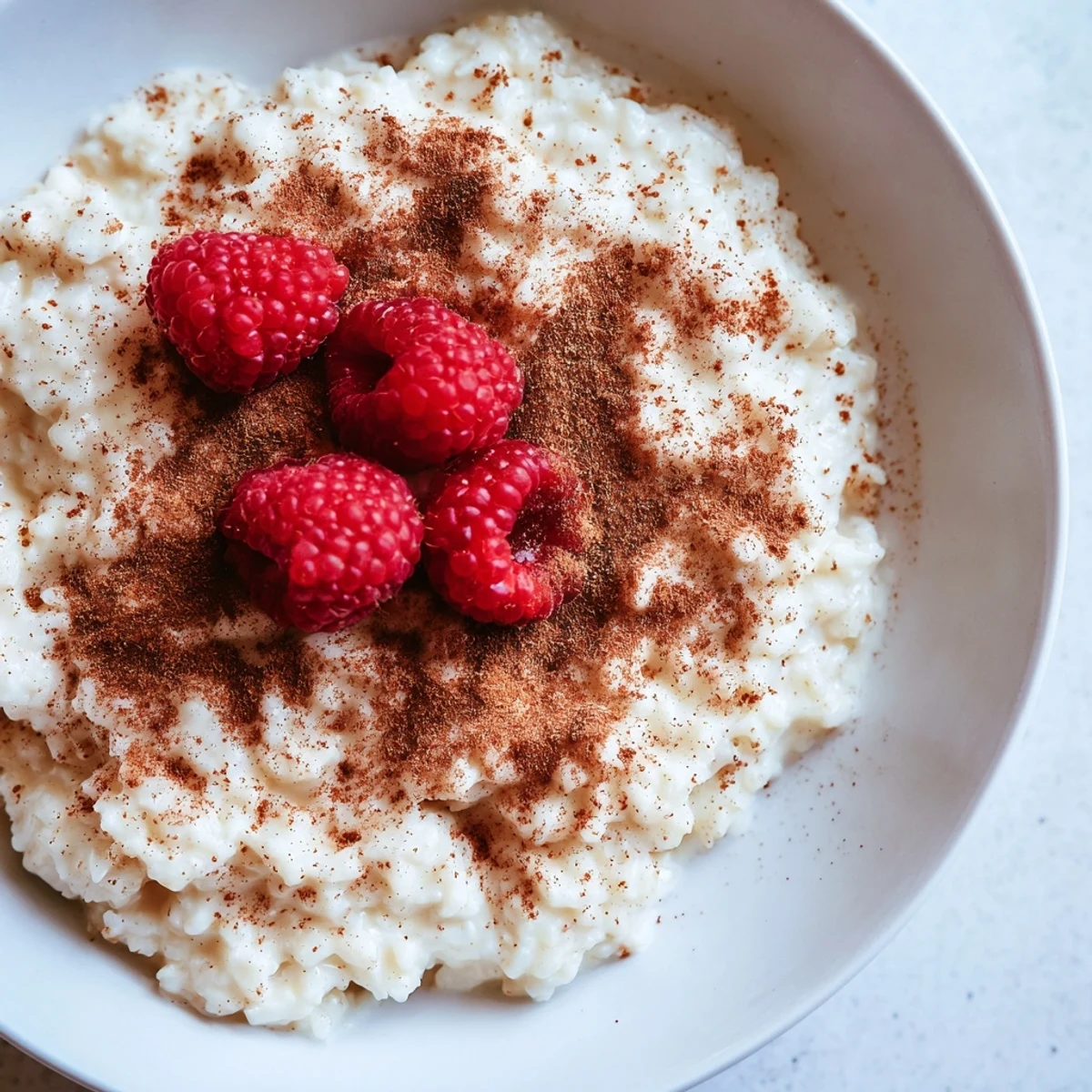 Imagine a spoonful of homemade creamy rice pudding, garnished with berries, pure comfort.