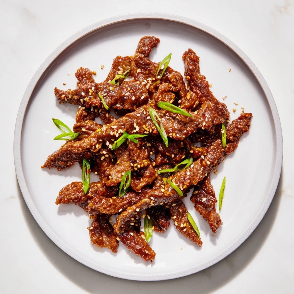 A delicious close-up of Beef Crispy, showcasing the perfectly fried, crunchy texture and sesame seeds.