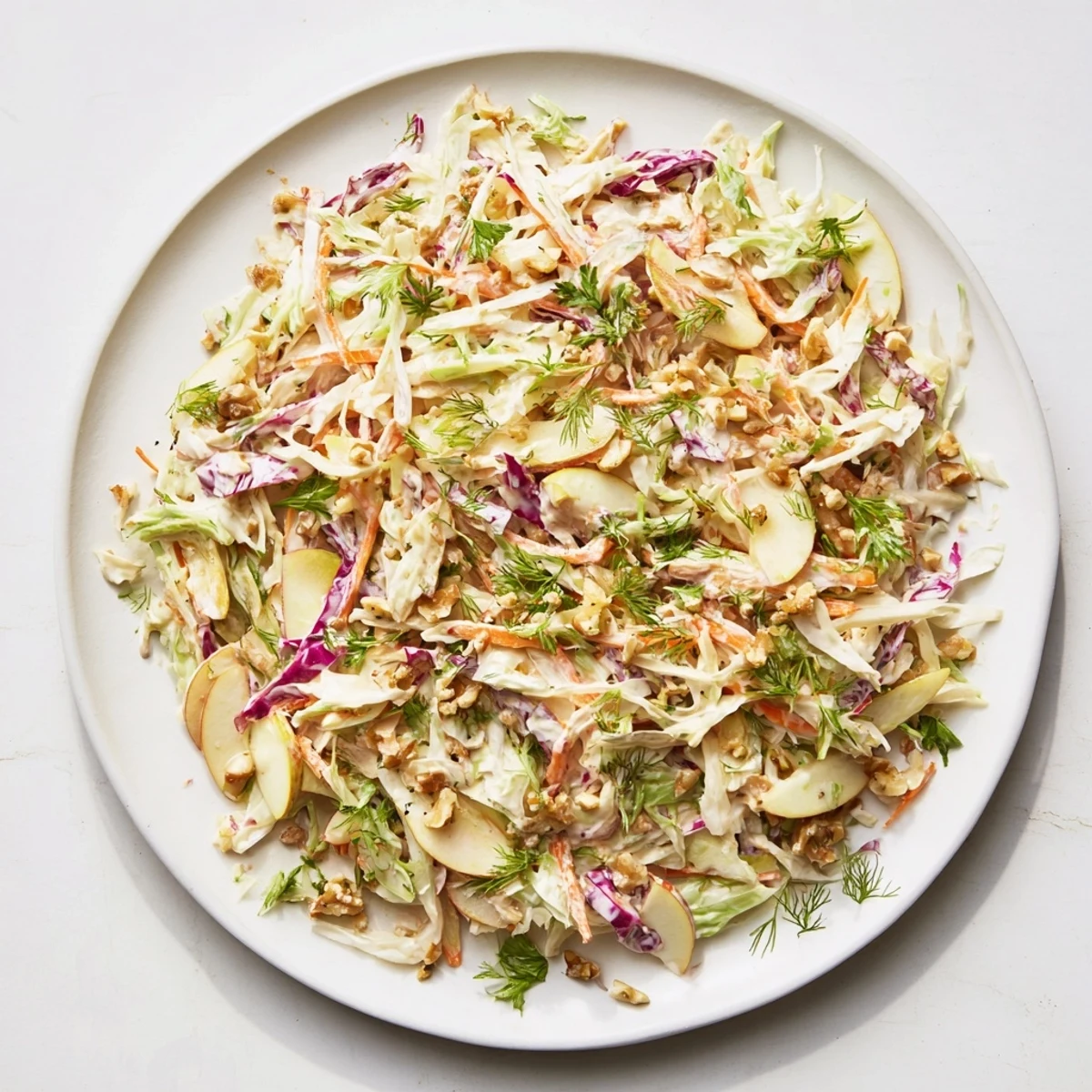 Homemade winter coleslaw with apple: a colorful, crunchy side dish, perfect for any holiday meal.
