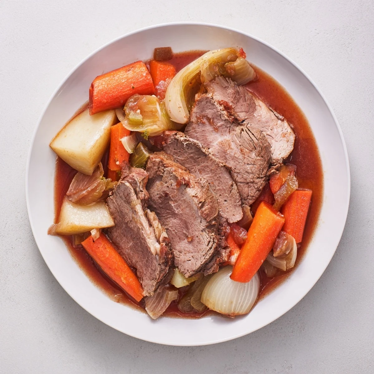 A flavorful French Braised Lamb Leg with Vegetables is meltingly tender and served with rich sauce.