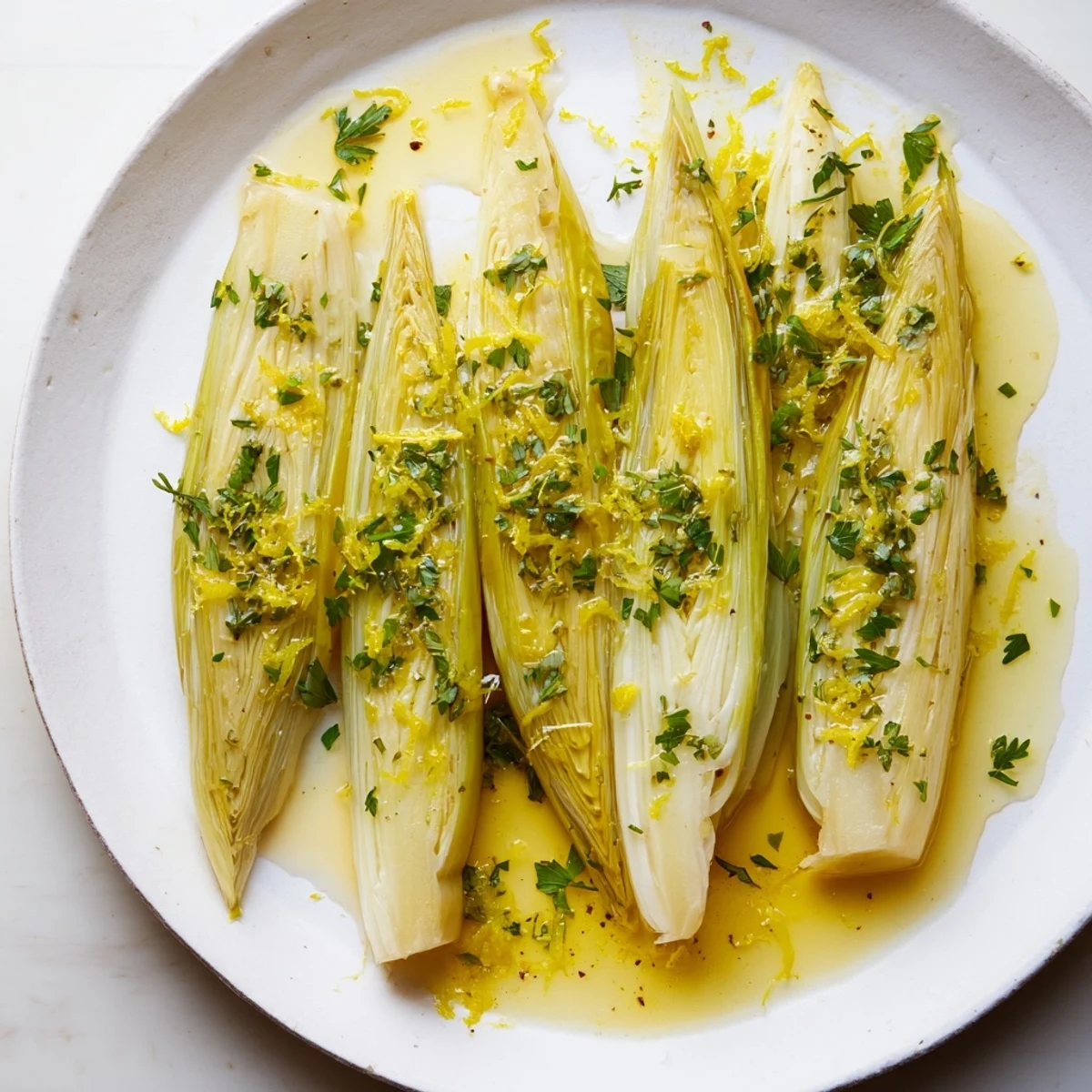 Savory braised leeks with herbs, cooked until softened and perfect for a simple, elegant dinner.