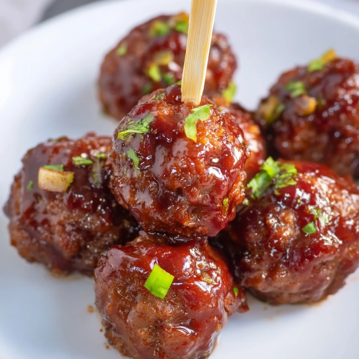 Golden-baked turkey appetizer meatballs glistening with tangy-sweet glaze on a festive platter.