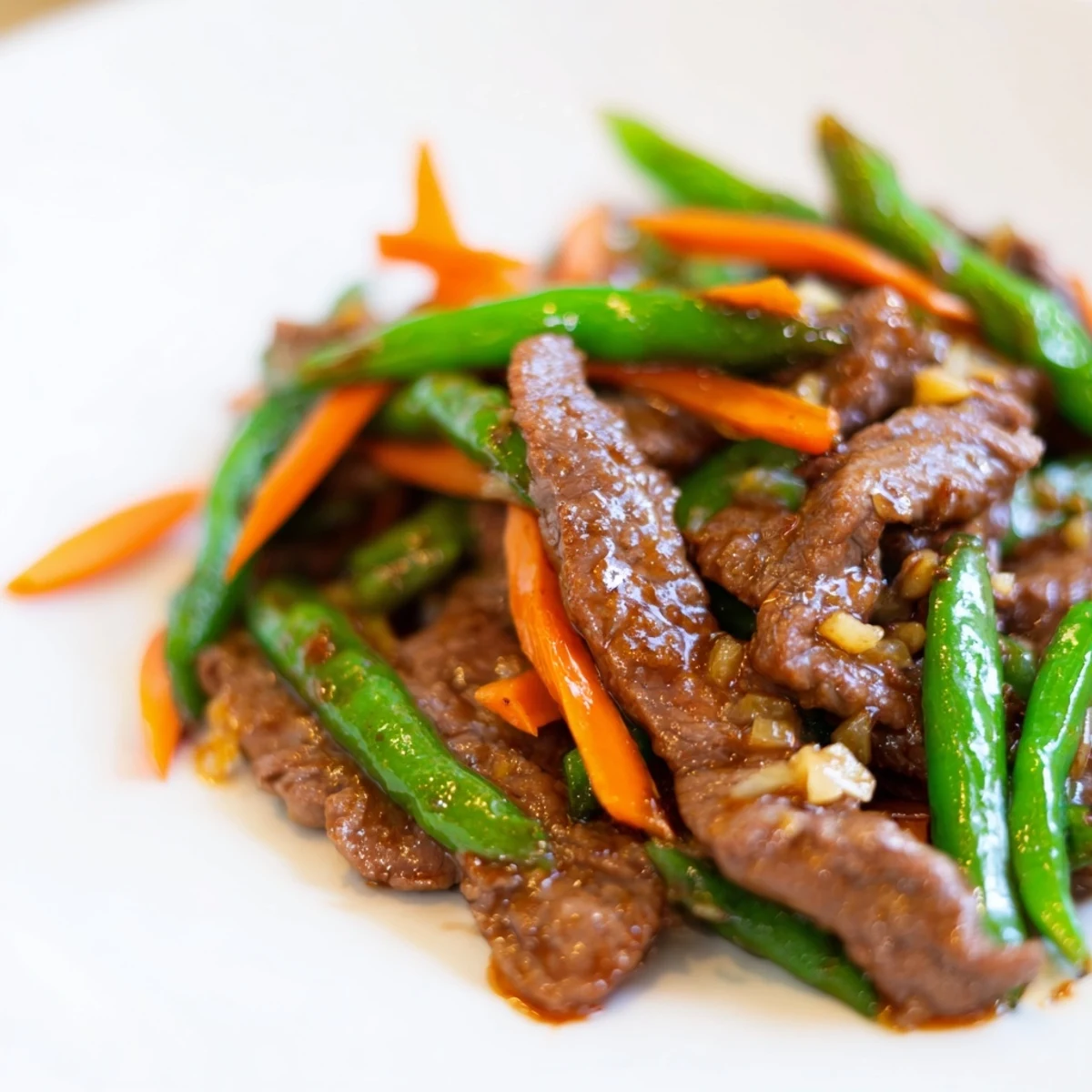 Finished with sesame seeds, the vibrant Beef Stir Fry with Snow Peas and Carrots looks ready for a delicious weeknight dinner.