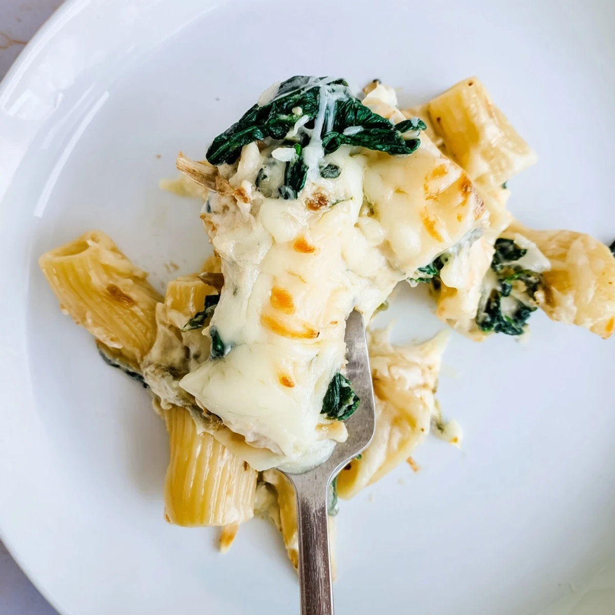 Fresh spinach and three melty cheeses blend inside this golden Creamy Spinach and Cheese Pasta Bake.