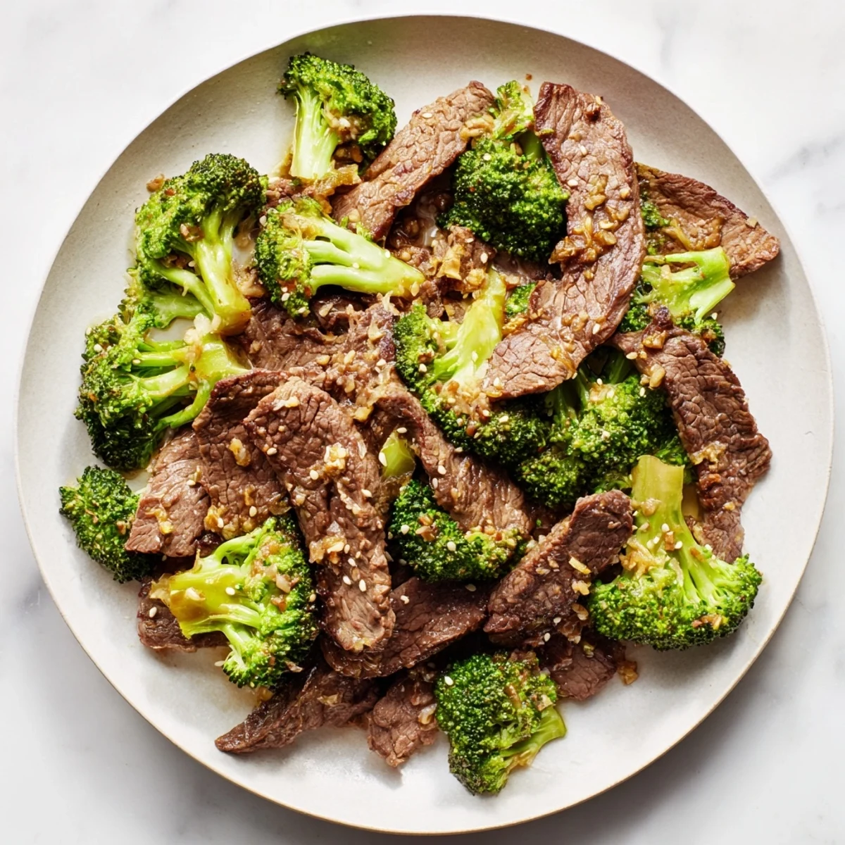 Tender beef slices and crisp broccoli florets glisten in a savory ginger sauce, served hot over fluffy white rice.