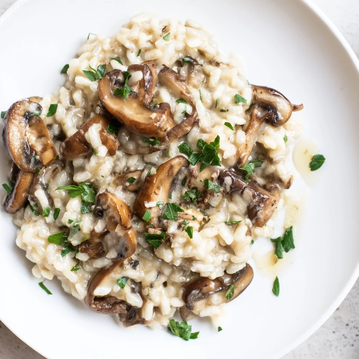 Garnished with fresh parsley, this luxurious risotto with truffle oil is served warm in a rustic ceramic bowl.