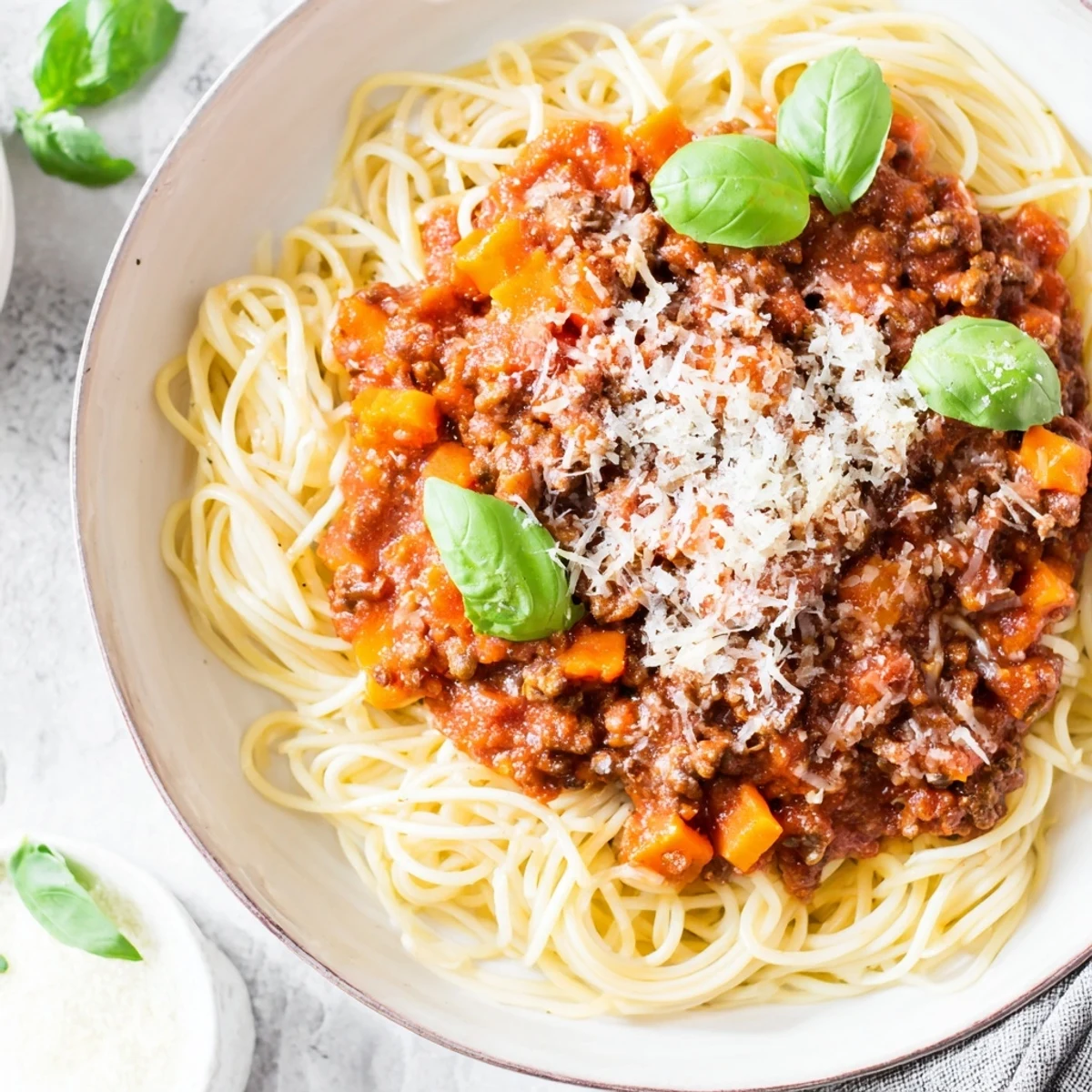 Close-up view of Beef Bolognese with spaghetti, showcasing perfectly cooked al dente pasta strands coated in a thick, savory meat sauce.