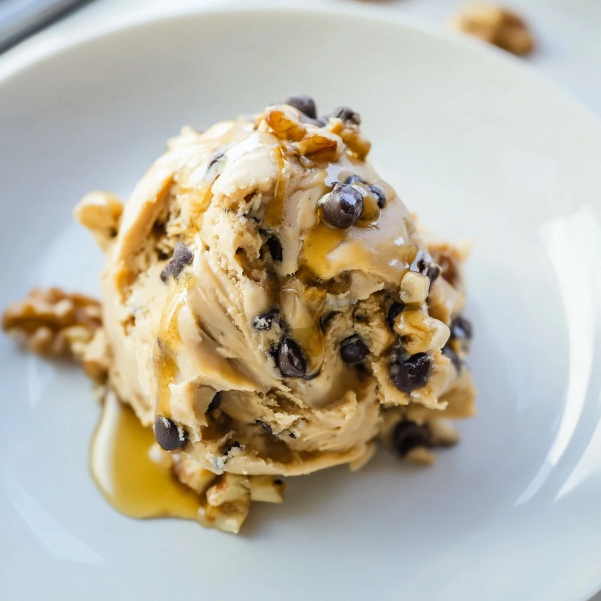 A bowl of Guilt Free Greek Yogurt Cookie Dough with dark chocolate chips and chopped walnuts, ready to serve.