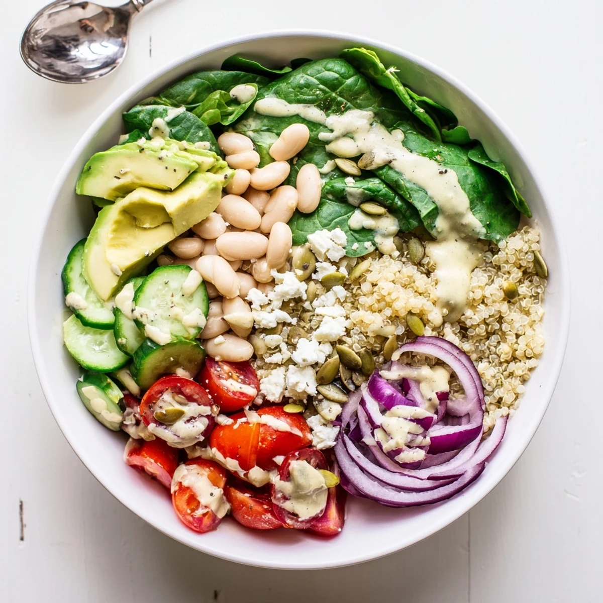 Hearty Spinach & White Bean Ultimate Protein Power Bowl served fresh with quinoa and tangy lemon-tahini dressing.