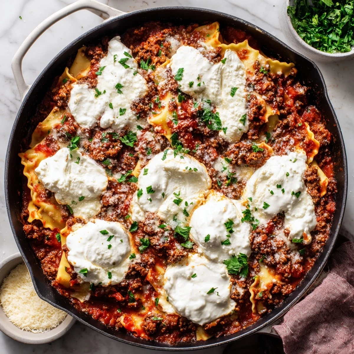Skillet Lasagna showcases melted mozzarella and Parmesan bubbling over a hearty meat sauce.