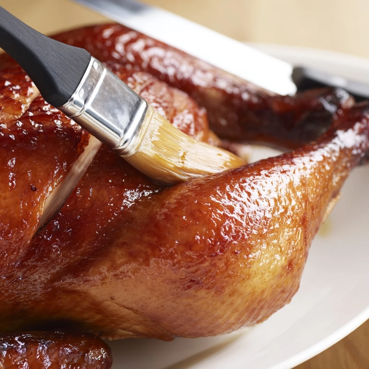 Juicy Shandong Roast Chicken glistens with honey glaze, served alongside fluffy steamed rice and stir-fried greens on a plate.