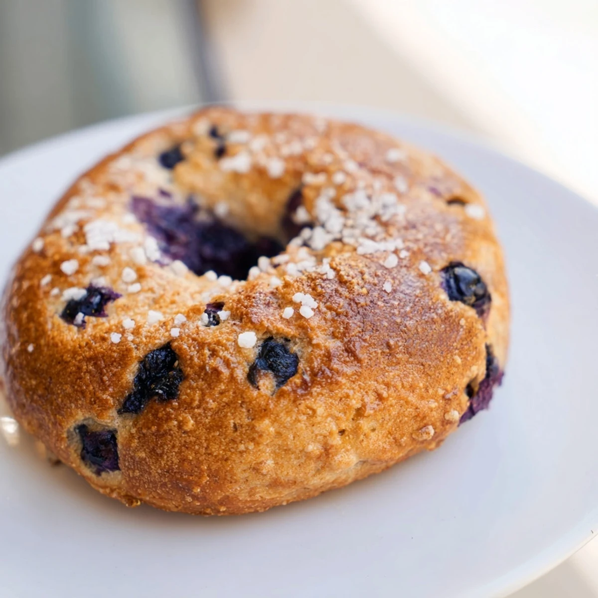 Gluten-Free Blueberry Bagels served warm with a schmear of cream cheese and fresh blueberries on the side.