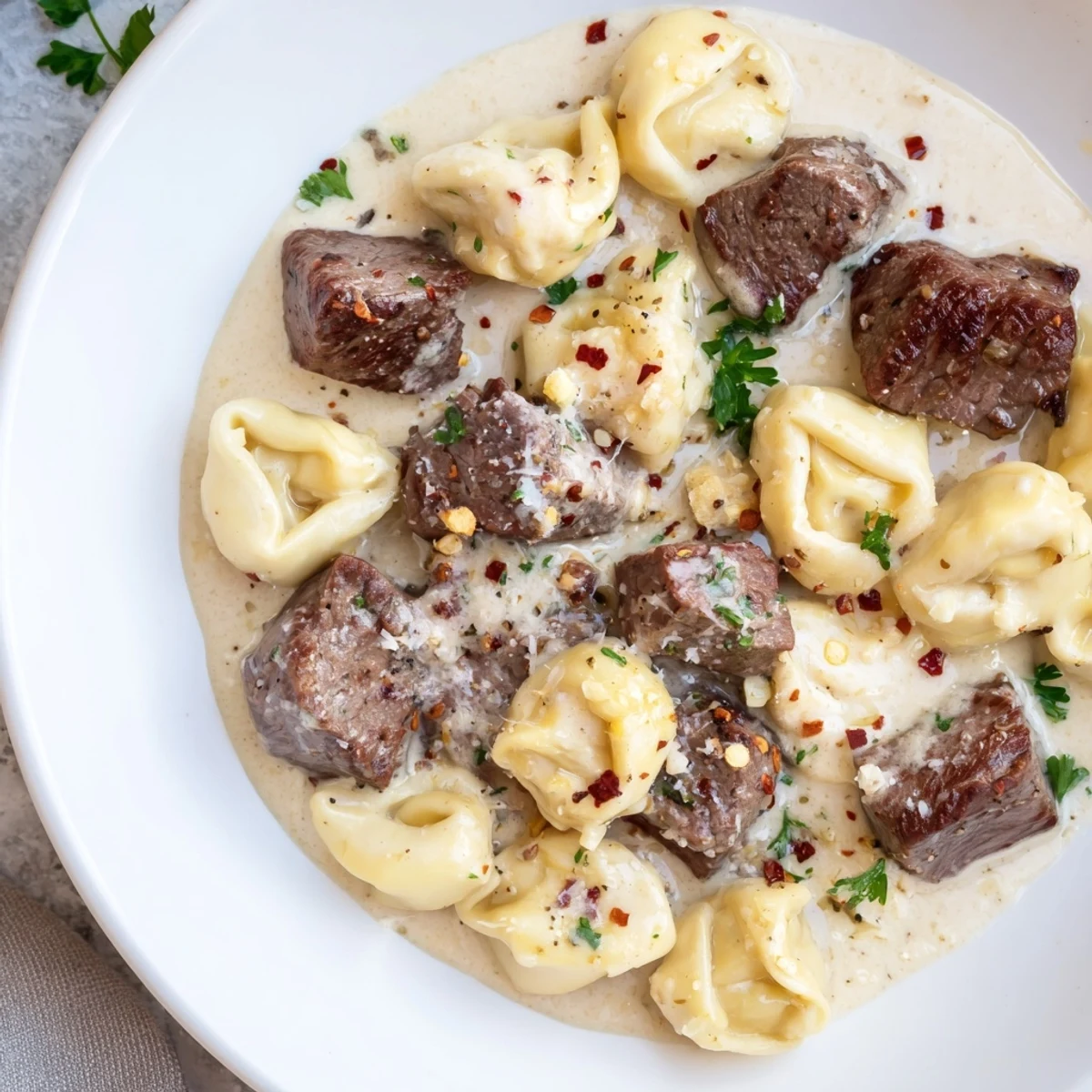 Creamy garlic steak tortellini with tender seared beef cubes and cheesy pasta in a rich sauce.
