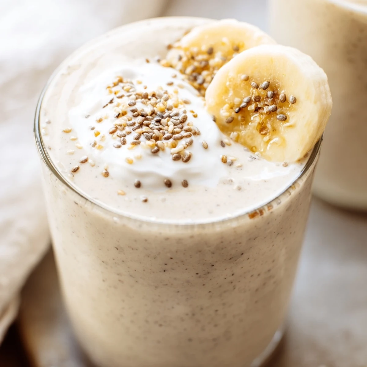 Healthy Greek yogurt banana smoothie blended with ice and served for a nutritious breakfast