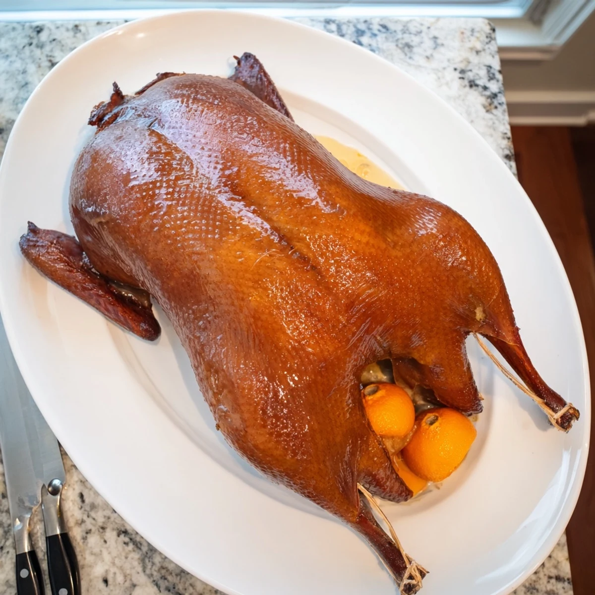 Golden roasted whole duck with crispy glazed skin seasoned with aromatic Chinese five-spice