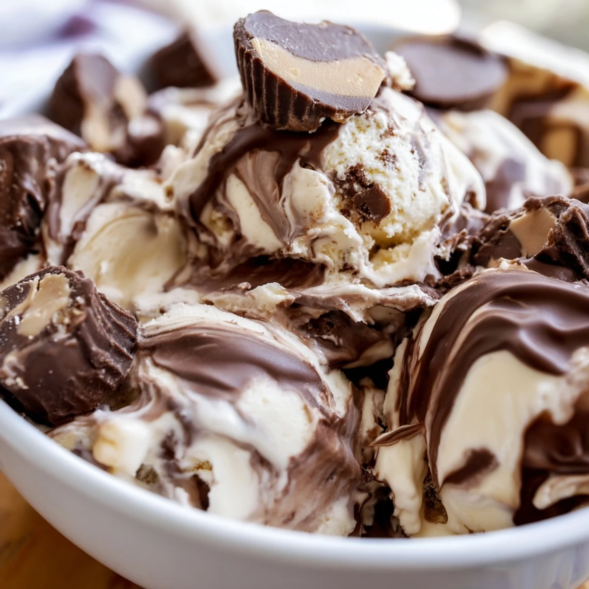 Creamy homemade moose tracks ice cream swirled with rich fudge sauce and chocolate peanut butter cups