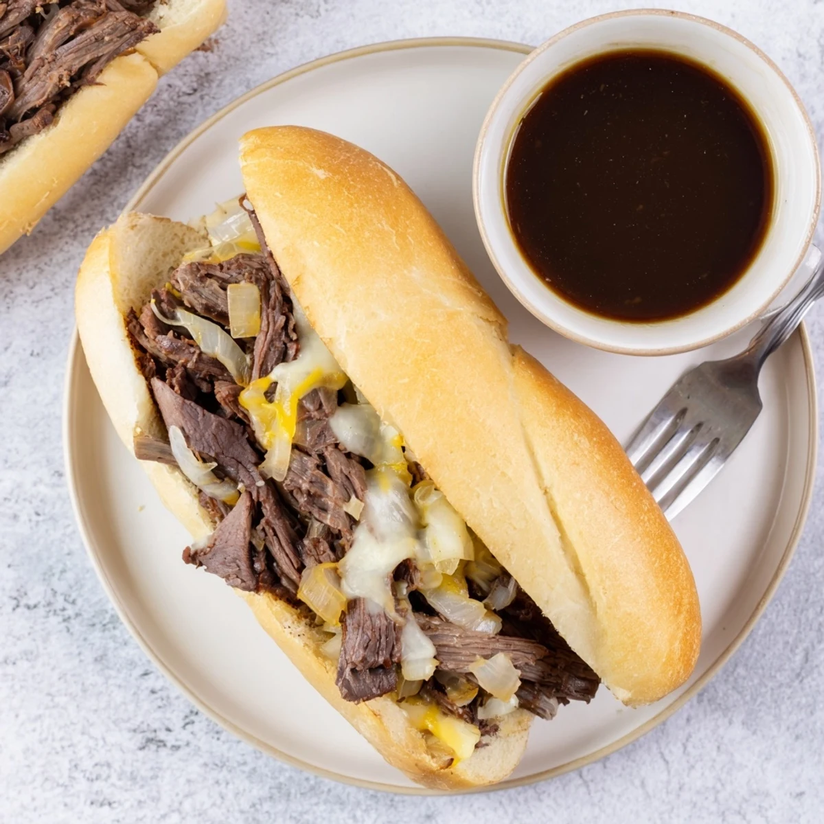 Golden toasted hoagie roll piled with tender Crockpot French Dip Sandwiches beef and melted provolone cheese