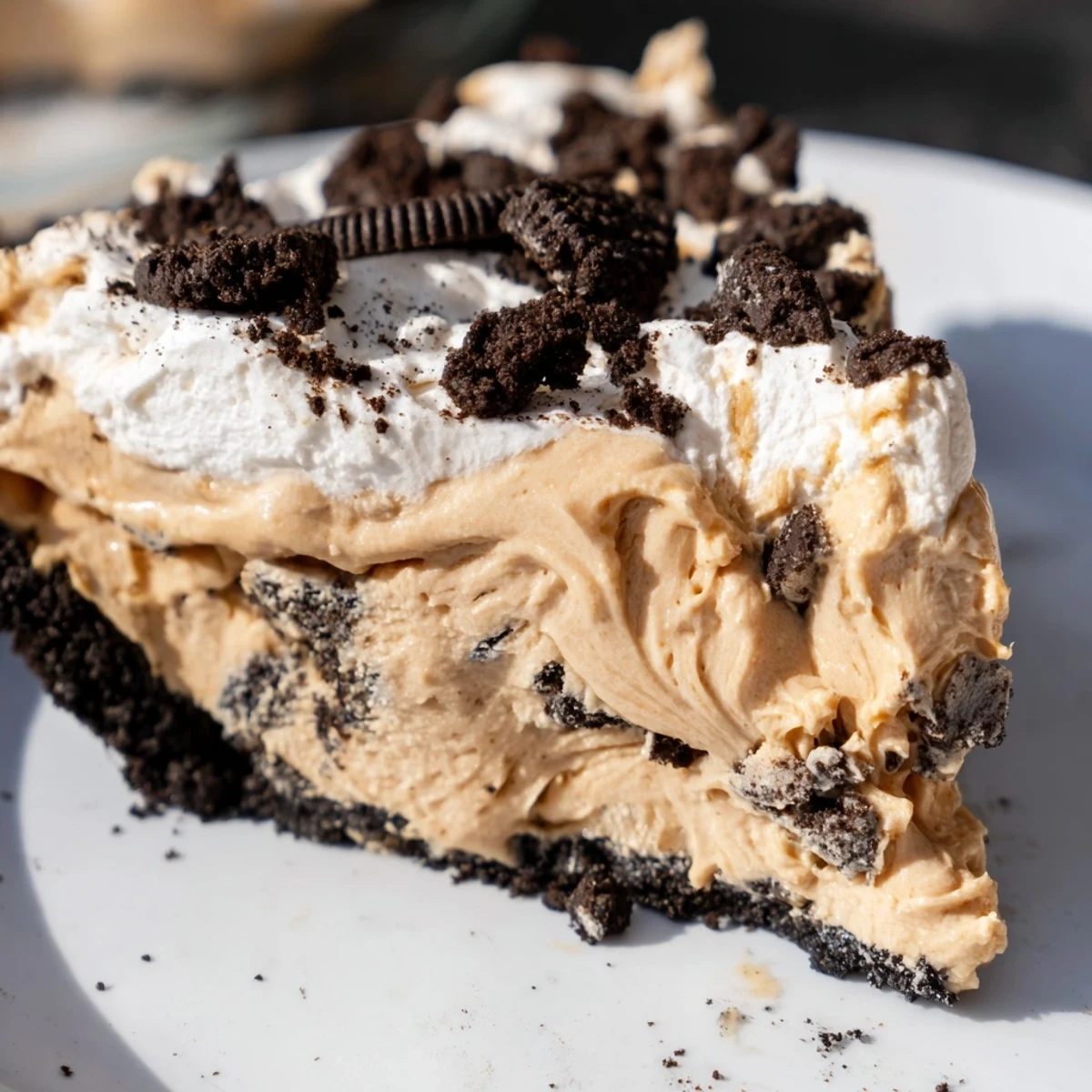 Rich peanut butter Oreo pie in a chocolatey crust topped with fluffy cream