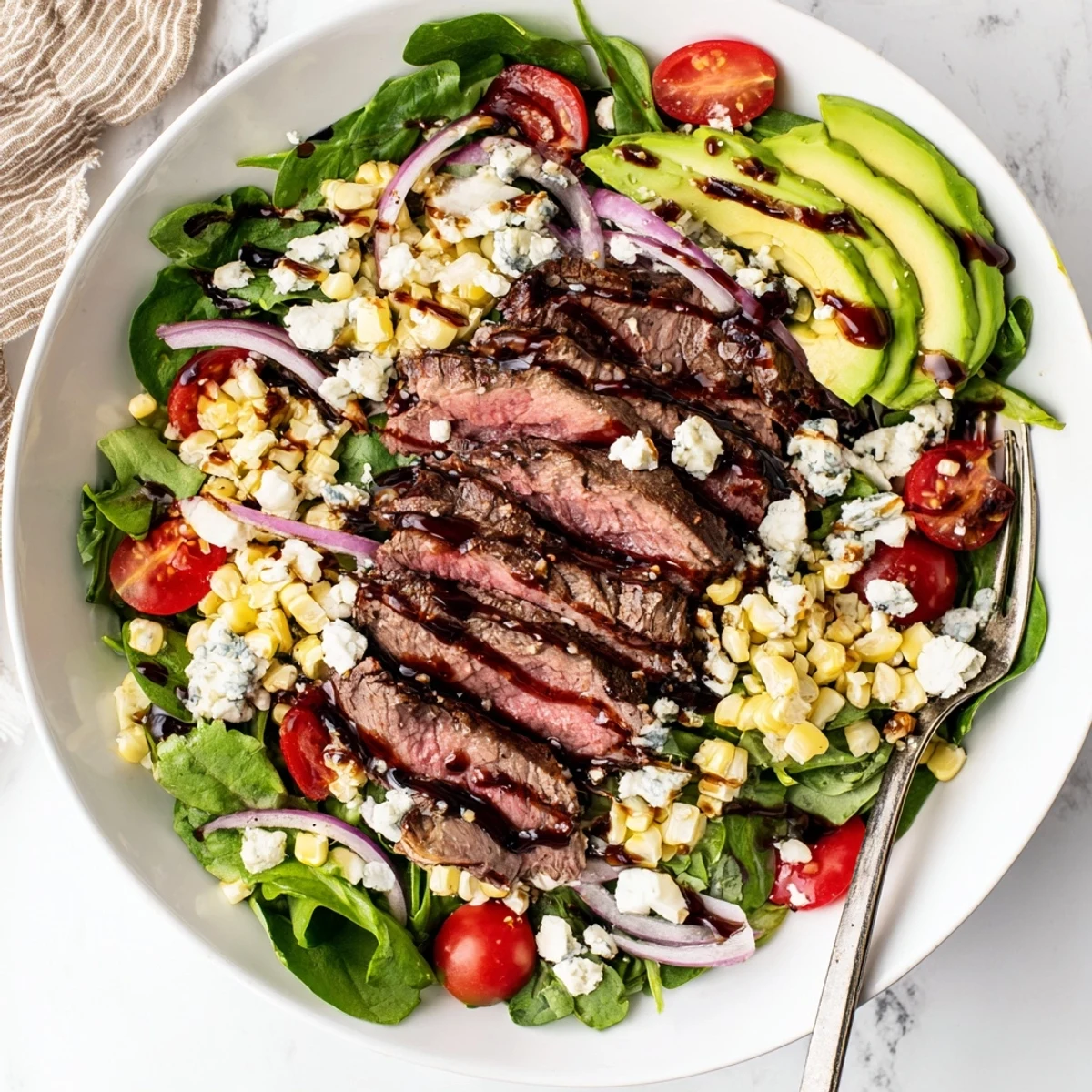 Crisp greens topped with juicy grilled steak sweet corn and crumbled gorgonzola