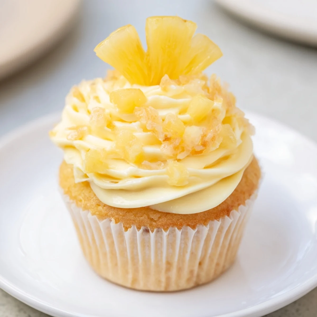 Chilled Dole Whip Cupcakes Recipe garnished with dried pineapple and maraschino cherry