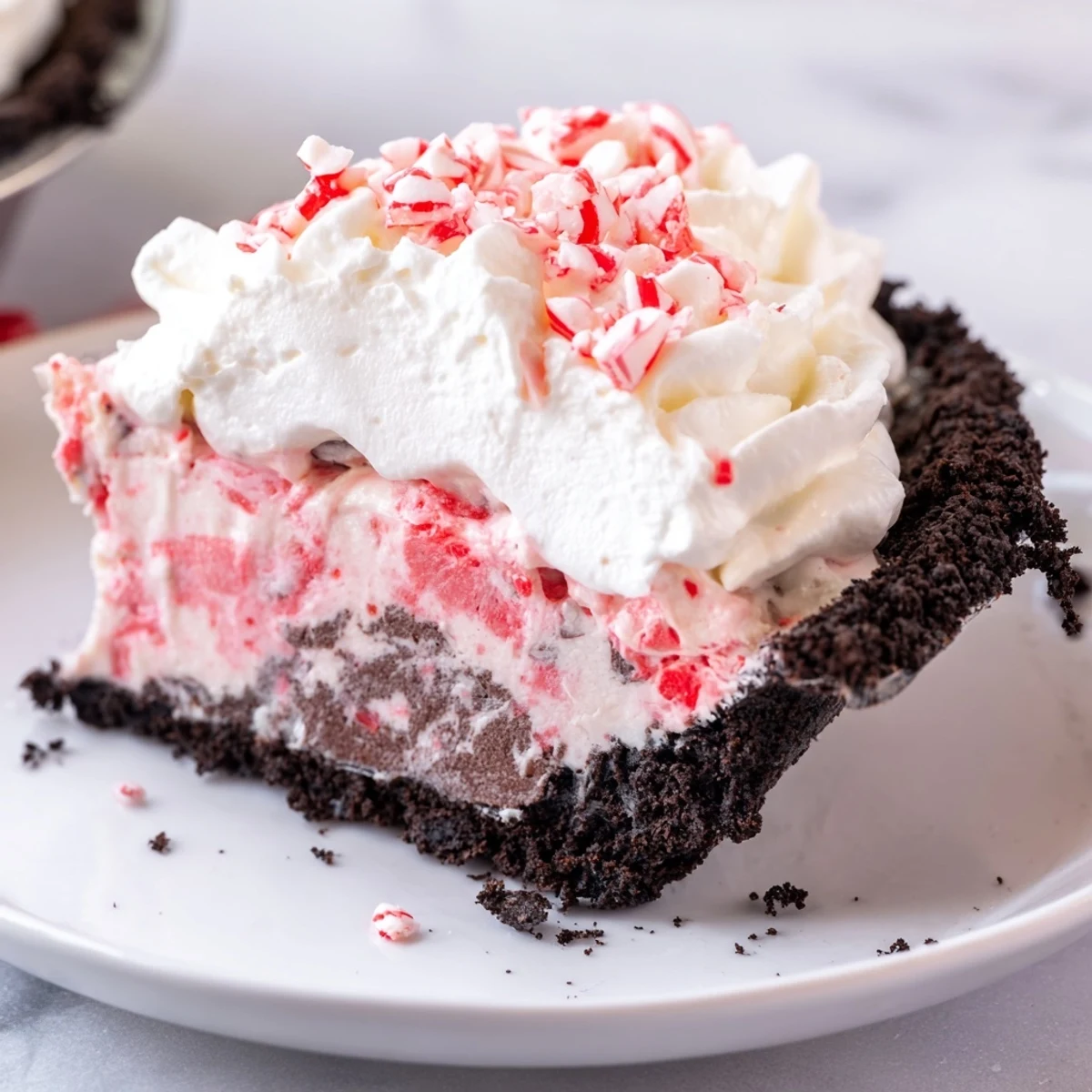 Candy Cane Pie with creamy peppermint filling, chocolate crust, and crushed candy topping