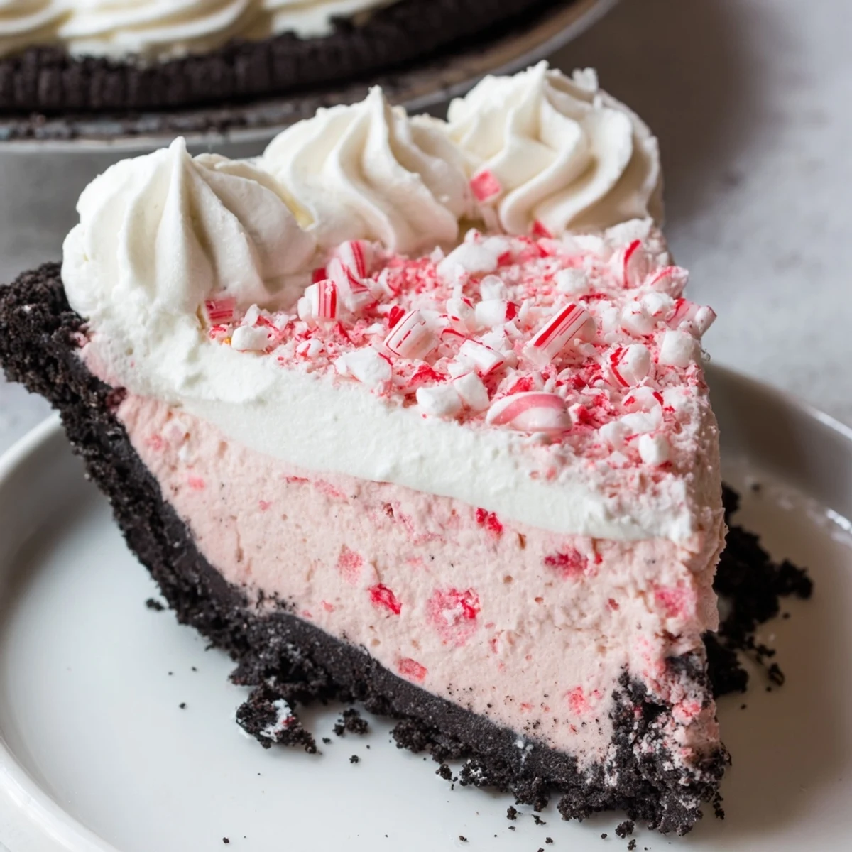 Slice of Candy Cane Pie chilled, fluffy marshmallow bits, festive red swirls