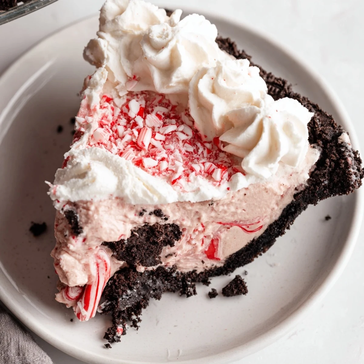 Homemade Candy Cane Pie served on plate, cool peppermint aroma, crunchy garnish
