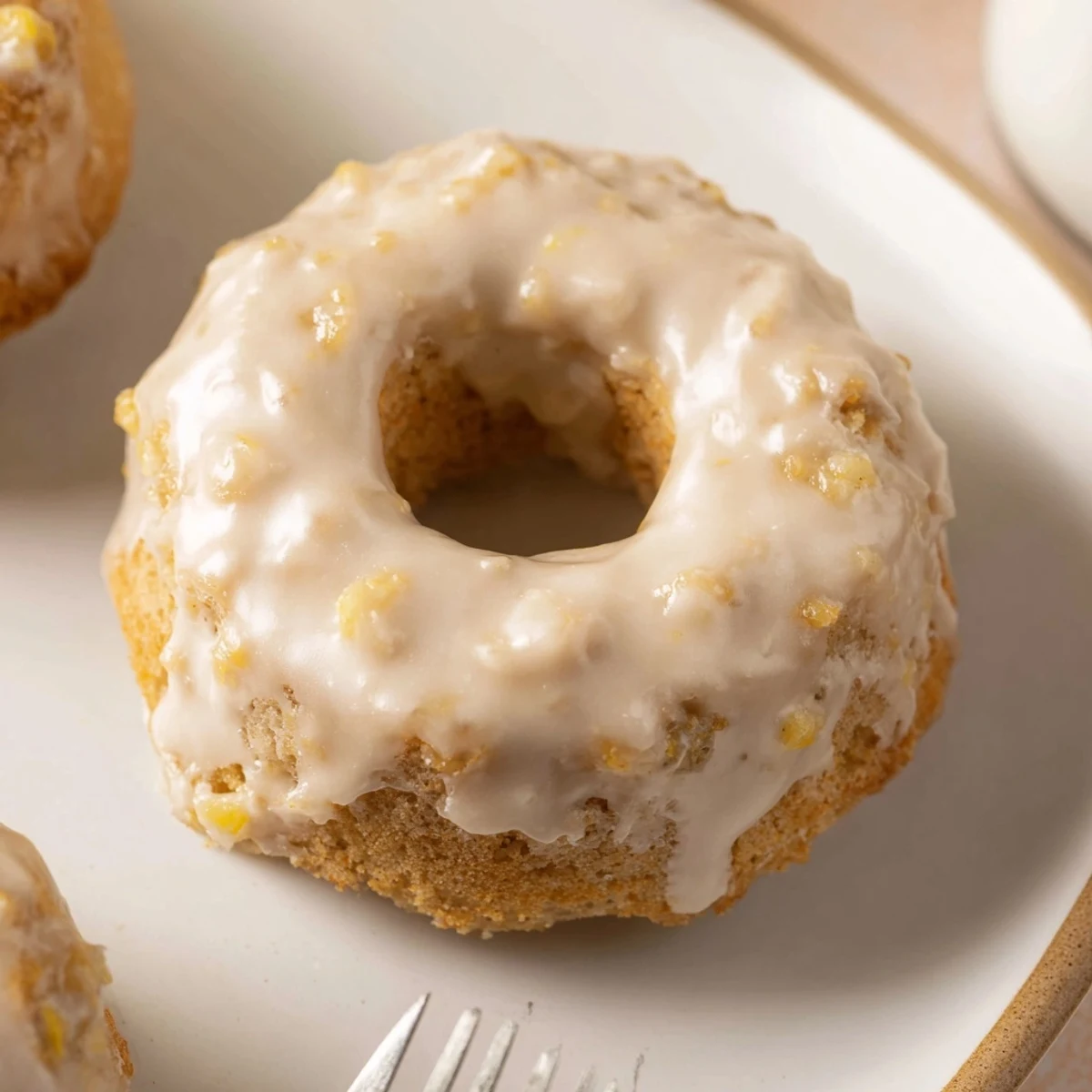 Warm Banana Donuts with golden tops, moist crumb, powdered glaze sheen