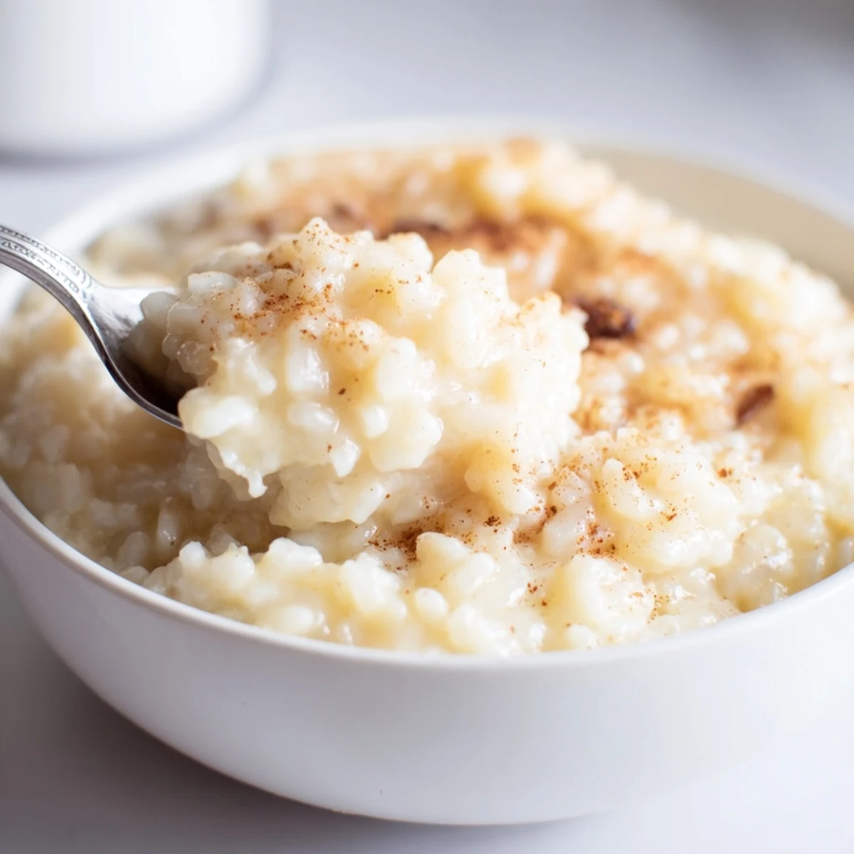 Creamy condensed milk baked rice pudding served warm with raisins and cinnamon