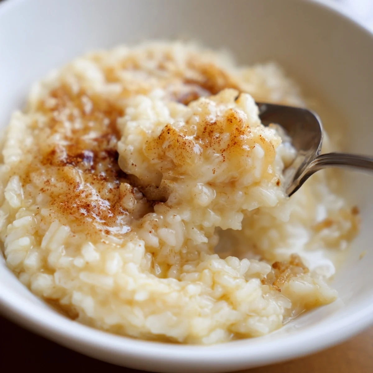 Warm Delicious Condensed Milk Baked Rice Pudding, golden top, cinnamon aroma, spoon-ready