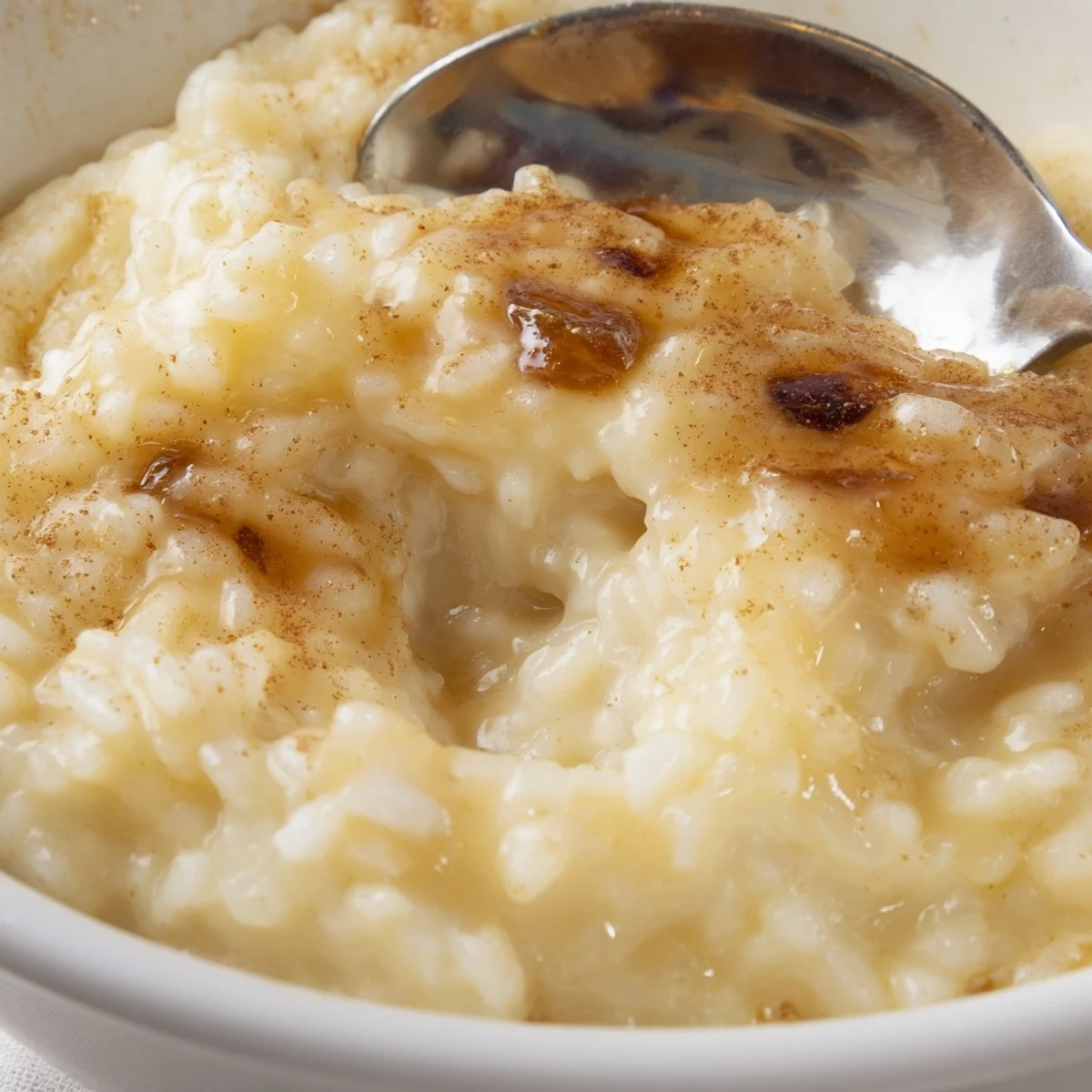 Chilled condensed milk baked rice pudding, silky texture, lightly spiced, garnished with berries