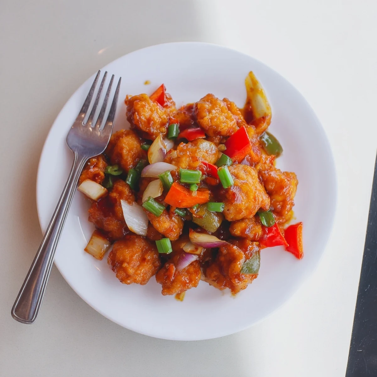 Flavorful Chilli Chicken Indo Chinese with glossy red sauce, crisp bell peppers