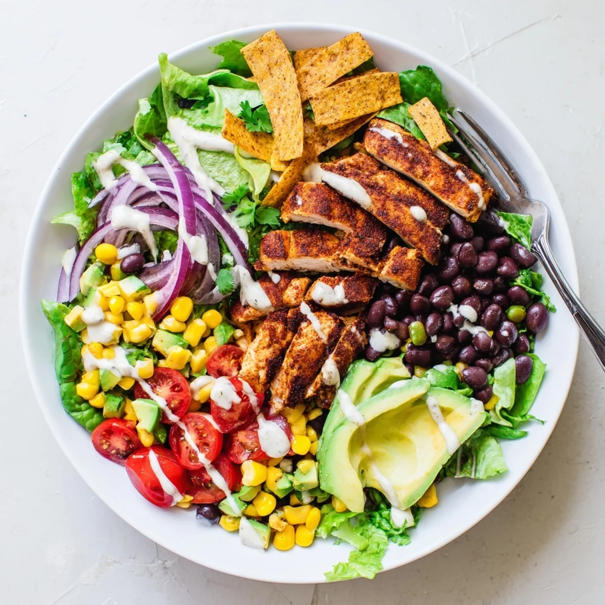 Healthy Southwestern chicken salad with tender spiced chicken breast, crisp bell peppers, cheese, and tangy sour cream dressing
