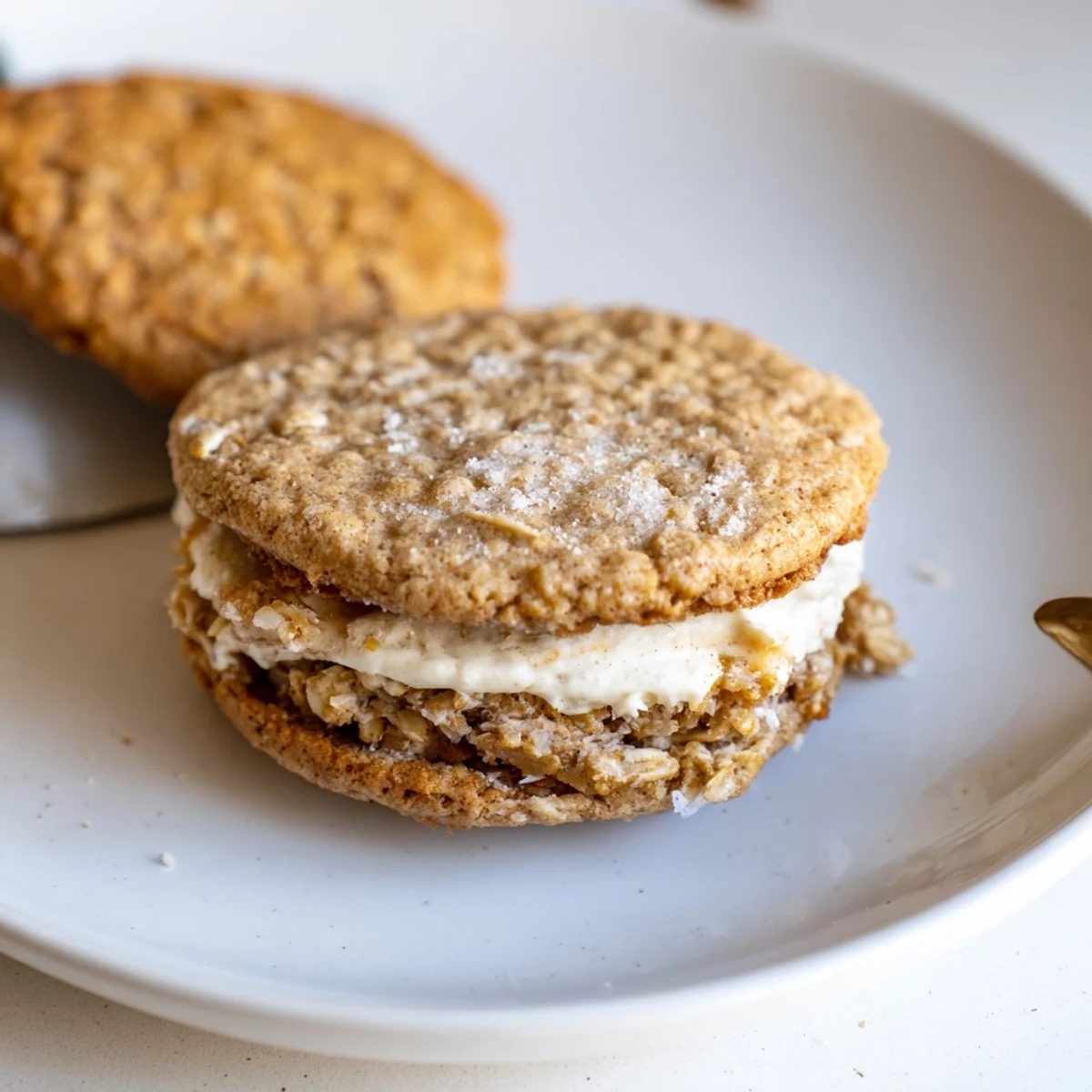Gluten Free Oatmeal Creme Pies stacked, golden edges and creamy vanilla center.