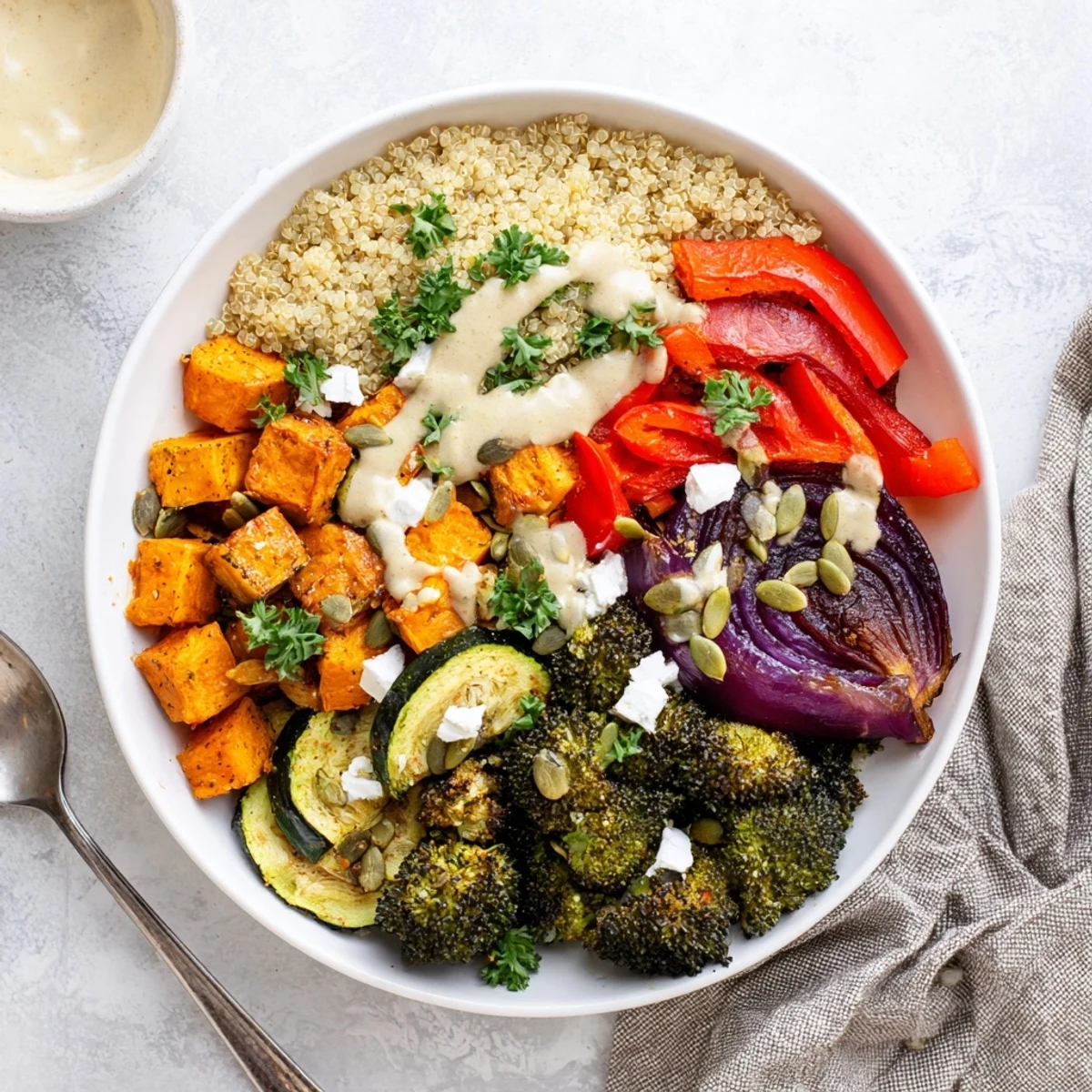 Colorful grain bowl with roasted vegetables, pumpkin seeds, and fresh herbs served warm