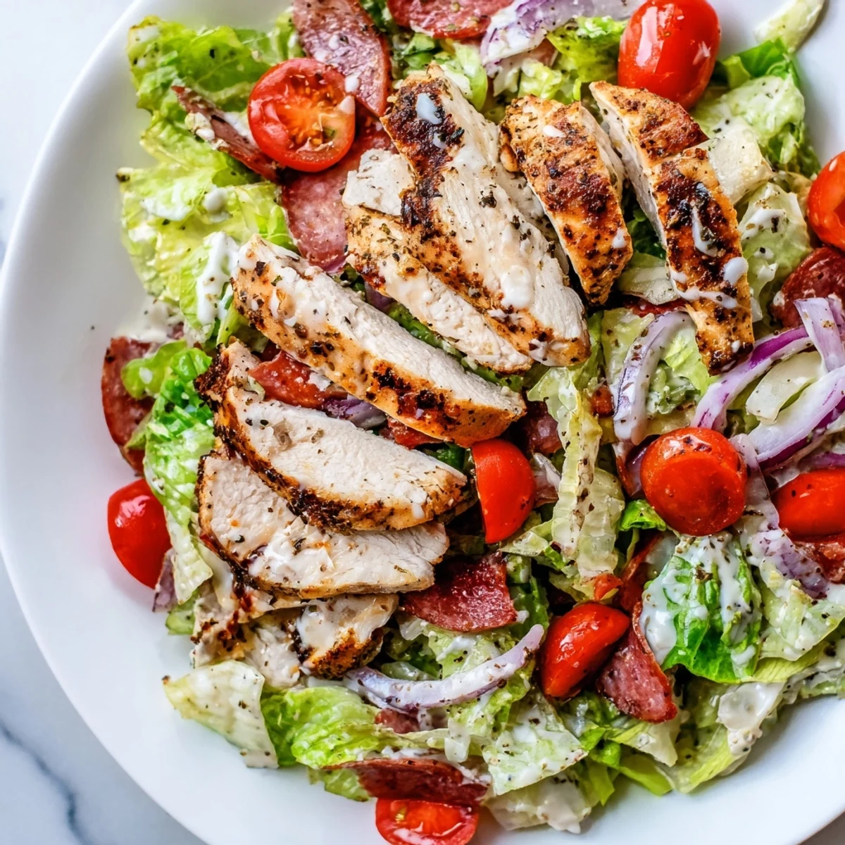 Italian Grinder Chicken Salad layered with crisp romaine, tangy pepperoncini, and savory deli meats