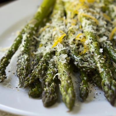 Golden, tender Roasted Asparagus with Parmesan and Lemon spears roasted on a baking sheet with olive oil and sea salt.