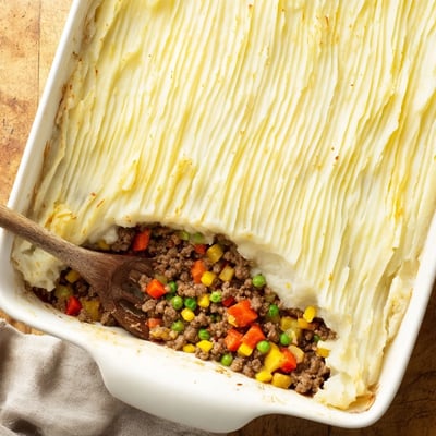 A close-up of Easy Shepherds Pie served in a dish, with a fork ready to enjoy.